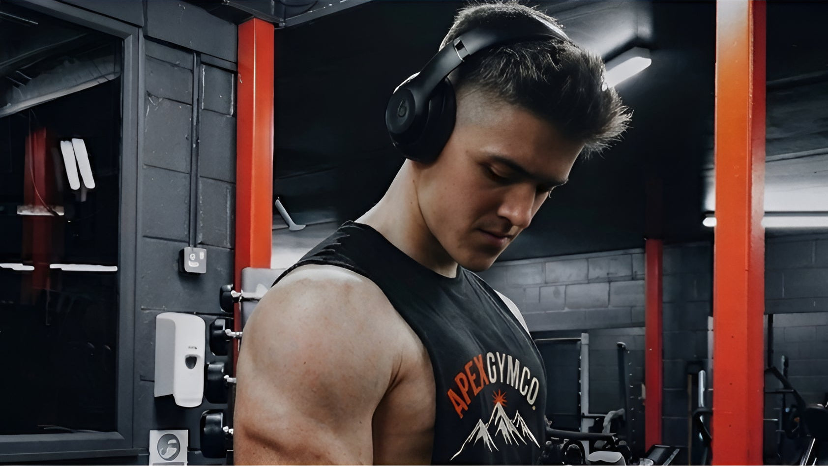 Man wearing headphones in a gym setting